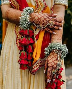 the bride's hands are decorated with flowers and garlands for her wedding day