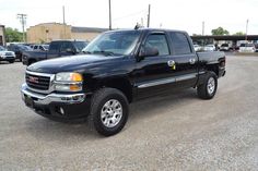 a black pickup truck parked in a parking lot