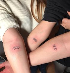 two people with matching tattoos on their arms