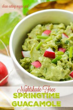 a white bowl filled with guacamole on top of a table next to radishes