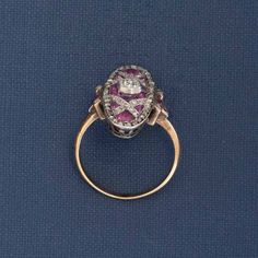 A classic Edwardian dinner ring, studded with rose cut diamonds and calibre cut pink sapphires. She spans across the top of the finger beautifully, giving you big flashes of color from the sapphires and subtle sparkle from those rose cuts. A beautiful ring to add a juicy pop of color to your collection of rings! Platinum & 18kt yellow gold Size 6.5 & resizable Center is estimated to be J/K color & Si2/I1 clarity Surrounding diamonds are estimated to be H/K color & VS/SI clarities Rubies are esti Luxury Pink Sapphire Ring With Rose Cut Diamonds, Marquise Ruby Ring With Rose Cut Diamonds, Oval Rose Cut Diamond Ring With Ruby Accents, Amethyst Diamond Ring With Rose Cut Diamonds For Anniversary, Wedding Rings With Pink Sapphire And Single Cut Diamonds, Pink Sapphire Rings With Single Cut Diamonds For Wedding, Pink Sapphire Wedding Rings With Single Cut Diamonds, Anniversary Pink Sapphire Ring With Rose Cut Diamonds, Victorian Ruby Ring With Single Cut Diamonds