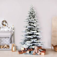 a white christmas tree with presents under it