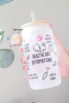 a person holding up a cup with the words healthcare affirmations on it and an illustration of cats