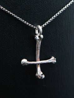 "Silver bone cross necklace, sterling silver round venice chain included. This handmade dark art gothic cross is made from 925 sterling silver with oxidated details. Each piece is made to meet customers desires, so let me know if you want something special included your very own version. Golden version is possible also! Pendants first class finish has a lifetime guarantee and it will be renewed when needed with a cost of postage.  Jewelry will be sent with FedEx International Economy, shipment is included in the price of jewelry. Upgrade to FedEx International Priority for even faster shipment. You can choose between five different finish: 'Polished' has darkened details and polished finish. 'Matte' has darkened details and matte finish. 'Bright white' is polished and details are left brig Gothic Sterling Silver Crucifix Necklace, Gothic Sterling Silver Cross Necklace, Petrine Cross, Black Metal Necklace, Upside Down Cross, Gothic Cross, Saint Peter, Gothic Crosses, Necklace Cross