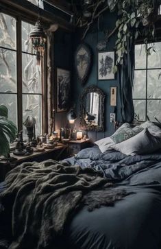 a bedroom with blue walls and lots of plants in the window sill, along with an unmade bed