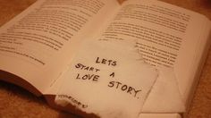 an open book with the words lets start a love story written on it