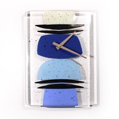 a clock made out of blue and white shapes