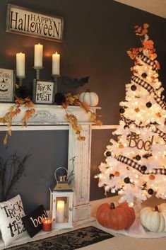 a decorated christmas tree in front of a fireplace with candles and pumpkins on the mantle