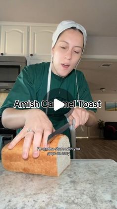 a woman in green shirt cutting bread on counter