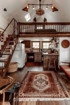 a living room filled with furniture and a stair case