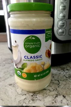 a jar of mayonnaise sitting on top of a counter next to an electric pressure cooker