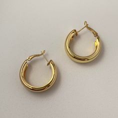 This chunky gold hoops earrings, Simple, elegant and stylish, these hoops will be forever in fashion and will complement any outfit and silhouette, whether it be a whimsical dress or tailored pant suit. The classic hoop earring never goes out of style! Material: Sterling Silver Needle/Brass/Gold Plated Earrings Size: 1.2"x1.0" Chic Gold-tone Small Hoop Earrings, Chic Small Hoop Huggie Earrings For Formal Events, Trendy Formal Hoop Earrings, Chic Gold Round Huggie Earrings, Chic Round Gold Huggie Earrings, Trendy Everyday Hoop Clip-on Earrings, Chic Gold Huggie Earrings, Chic Metal Hoop Huggie Earrings, Chic Hoop Huggie Earrings For Formal Occasions