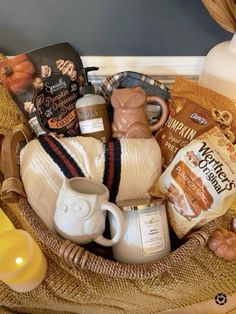 a basket filled with coffee and snacks on top of a table