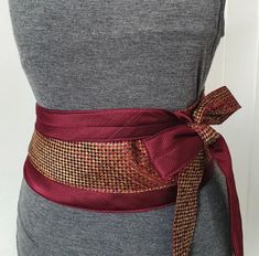 This gold and maroon belt reminds me.of the scales of a dragon. This unique, one of a kind Japanese obi belt is upcycled from silk ties. 1 size, it wraps around your waist and you can tie it at the front, back or side as in the video. This quirky and versatile belt can be dressed up or down: over a dress, over jeans and a basic top etc A statement belt that makes a perfect gift for her. Adjustable Gold Belt As A Gift, Elegant Handmade Adjustable Belt, Elegant Adjustable Belts As Gift, Elegant Adjustable Belt For Gift, Handmade Adjustable Belts For Gifts, Handmade Adjustable Belts As A Gift, Obi Belt, Quirky Gifts, Suspender Belt