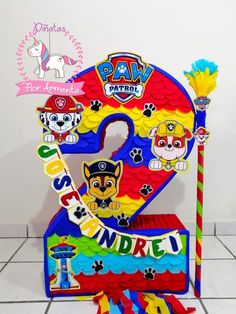 the paw patrol birthday cake is decorated in bright colors and features paw's numbers