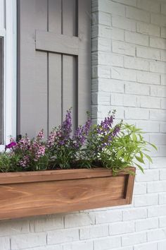 a window box with purple flowers in it