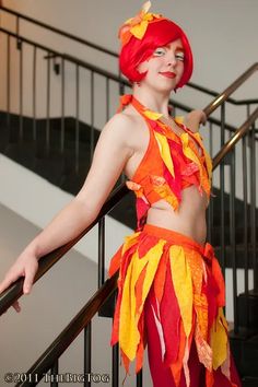 a woman in a costume is standing on the stairs with her hands behind her back