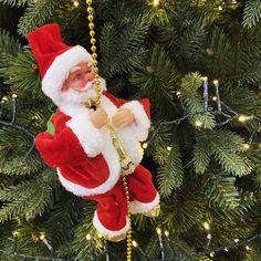 a santa clause ornament hanging from a christmas tree