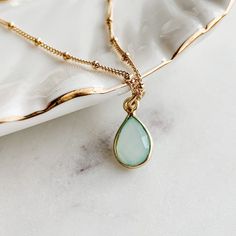 Perfect for minimalist styling. A dainty blue chalcedony gemstone set in a gold vermeil (heavy gold plating over sterling silver) frame and suspended on a 14K gold-fill necklace chain. Available in other gemstone charms. Chalcedony is one of the birthstones for March and this necklace makes a lovely birthday gift.   >Pendant height: 18 mm; Pendant width: 8 mm > 18" necklace chain shown in product photo and is our most popular necklace length > Looks lovely layered with other necklaces SHIPPING: Popular Necklaces, Pendant Necklace Simple, Gemstone Pendant Necklace, Gold Filled Necklace, Pendant Necklace Gold, Necklace Simple, Teardrop Necklace, Necklace Gemstone, Solid Gold Jewelry