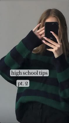 a woman is looking at her phone while wearing a green and black striped sweater with the words high school tips pt 2