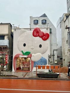 a large hello kitty mural on the side of a building