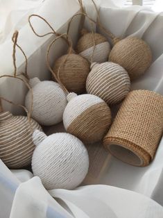 white and beige balls are tied together in twine with burlocks on them