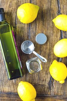 there are lemons, measuring spoons, and other items on the wooden table