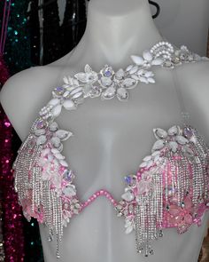 a white mannequin with pink and silver jewelry on it's neckline