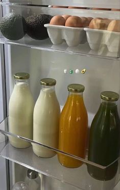 an open refrigerator filled with lots of different types of juices and condiments