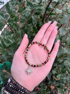 Handmade  Red and Green Christmas Star Holiday Charm Beaded stretchy Bracelet Adjustable Beaded Stretch Bracelet For Christmas, Red Stretch Bracelet For Christmas, Adjustable Red Festive Bracelet, Red Christmas Bracelets For The Holidays, Red Beaded Stretch Bracelet For Christmas, Star-shaped Red Bracelets As Gifts, Red Star-shaped Bracelet For Gift, Adjustable Red Charm Bracelet, Red Star-shaped Beaded Jewelry