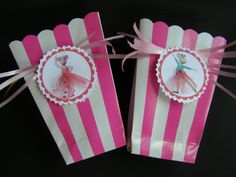 two pink and white striped bags with ballet pictures on them, tied to each other