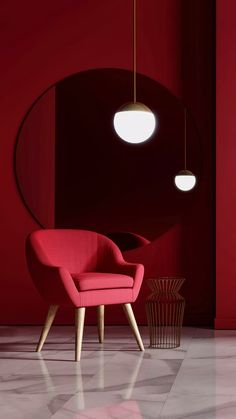 a pink chair sitting in front of a red wall next to a round light fixture