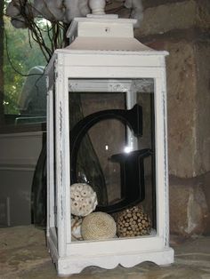 an old fashioned lantern with shells in it