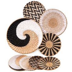 four woven baskets with black and white designs on the bottom one has a spiral design