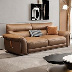 a brown leather couch sitting in a living room