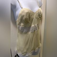 Beautiful Light Yellow And White Lace 100% Silk Camisole With Adjustable Straps And Buttons Down The Back. New With Tags, However There Is Some Light Snagging On The Bust Area (As Seen In The Last Pic). However, It Is Barely Noticeable And Can Possible Be Shaved Off? Italian Size 40, Which Is A Us Size Medium I’m Trying To Sell Most Of My Belongings So I Can Move Out Of The Country. So Feel Free To Make Me An Offer! However, Please Remember, All Sales Are Final. Thank You! Questions? Leave A Com Yellow Tank Top With Built-in Bra For Spring, Vintage Spring Camisole With Spaghetti Straps, Cream Camisole With Adjustable Spaghetti Straps, Vintage Summer Top With Built-in Bra, Vintage Spaghetti Strap Camisole For Spring, Beige Camisole Tank Top For Daywear, Summer Vintage Top With Built-in Bra, Cream Camisole With Built-in Bra And Spaghetti Straps, Fitted Cream Tank Top With Lace Trim