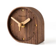 a small wooden clock with the word tomwood on it's face and hands