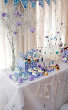 a table topped with cupcakes and cakes covered in frosting