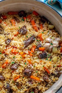 a pot filled with rice and vegetables on top of a table