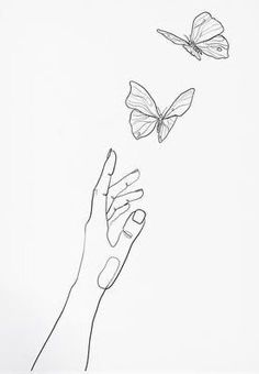 two butterflies flying in the sky above a hand reaching for something to fly towards them