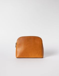 a tan leather pouch sitting on top of a white surface