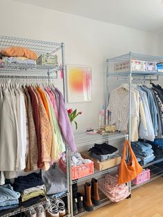 an organized closet with clothes and handbags