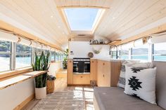 the interior of a tiny home with wood paneling on the walls and ceiling, along with windows