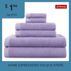 towels are stacked on top of each other in front of a blue background with the words, home expressions sold & stripe