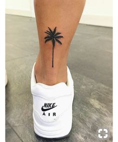 a small palm tree tattoo on the ankle