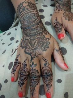 a woman's hand with henna tattoos on it