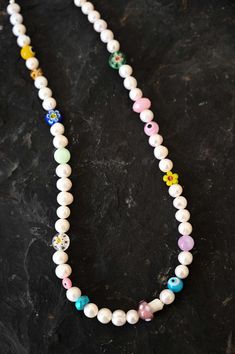 Revive the child in you with this playful and colorful Mother of Pearl charm necklace with assorted fun and colorful kidult beads. This necklace is a beautiful mix of classic elegance and youthful energy. The white Mother of Pearl beads give a timeless touch, while the kidult beads add a pop of color and playfulness. Mother of Pearl is a gemstone that is said to promote inner peace and emotional balance. The kidult beads add a touch of whimsy and fun, making this necklace a perfect accessory for Pearl Charm Necklace, Fun Girl, Mala Necklace, Emotional Balance, Pearl Charms, Crystals And Gemstones, Classic Elegance, Pearl Beads, Inner Peace