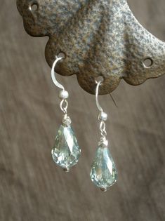 Faceted, pale green Austrian glass crystal teardrops dangle strikingly from sterling silver French ear wires, measuring 1 and 1/4 inches in length. Light and light-catching! Suitable for sensitive skin; silicone ear backs included. Gift-packaged and ready for giving or wearing! With warm thanks, Deanna Ross Owner and Designer, Spirit Arts Jewelry Handmade in Monterey, California Green Sterling Silver Teardrop Earrings, Green Sterling Silver Teardrop Earrings Hypoallergenic, Sterling Silver Drop Crystal Earrings, Sterling Silver Drop Crystal Earrings With Ear Wire, Silver Drop Crystal Earrings With Ear Wire, Sterling Silver Teardrop Crystal Earrings With Ear Wire, Silver Briolette Crystal Earrings With Ear Wire, Silver Teardrop Crystal Earrings With Ear Wire, Sterling Silver Teardrop Crystal Earrings