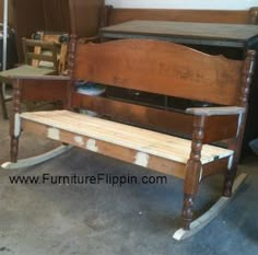 a wooden bench sitting in the middle of a room