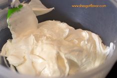 a bowl filled with whipped cream sitting on top of a table